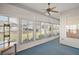 Bright sunroom featuring carpet, a ceiling fan, and multiple windows for natural light at 5095 China Sea Dr, Tavares, FL 32778
