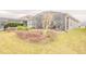 View of the backyard, showcasing a screened-in lanai and lush landscaping; a serene outdoor retreat at 525 Narrow View Ln, Groveland, FL 34736