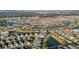 Expansive aerial view of a community featuring winding canals and mature trees, showcasing numerous homes at 5819 White Ibis, The Villages, FL 32163