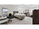 Bright bedroom featuring a ceiling fan, neutral walls, tray ceiling and coordinating furniture at 5819 White Ibis, The Villages, FL 32163