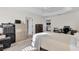Bedroom boasts a tray ceiling, neutral walls and adjoins another room visible through doorway at 5819 White Ibis, The Villages, FL 32163