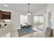 Bright dining area featuring a table with seating, sliding glass doors, offering a seamless transition to the outdoors at 5819 White Ibis, The Villages, FL 32163