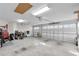 Spacious three car garage with automatic doors, overhead lighting, and ample room for storage at 5819 White Ibis, The Villages, FL 32163