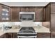 The kitchen features granite countertops, wooden cabinets, modern stainless steel appliances, and ample space at 5819 White Ibis, The Villages, FL 32163