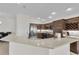 The kitchen features granite countertops, stainless steel appliances, wooden cabinets, and an open layout at 5819 White Ibis, The Villages, FL 32163