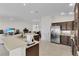 The expansive kitchen features stainless steel appliances, granite countertops, wood cabinets and an open layout at 5819 White Ibis, The Villages, FL 32163