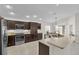 Well-equipped kitchen boasts stainless steel appliances, wooden cabinets, granite countertops, and functional design at 5819 White Ibis, The Villages, FL 32163