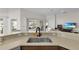 The modern kitchen has granite countertops, a stainless steel sink, wood cabinets, and offers a bright, functional layout at 5819 White Ibis, The Villages, FL 32163