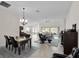 Open-concept living and dining area with tile floors and natural light, ideal for entertaining and relaxation at 5819 White Ibis, The Villages, FL 32163