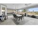 Screened patio featuring a dining table with seating, ceiling fans, and views of a lake at 5819 White Ibis, The Villages, FL 32163
