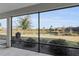 Expansive view of lake from screened lanai, with outdoor grill and landscaping at 5819 White Ibis, The Villages, FL 32163