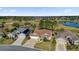 Aerial shot of the home on the golf course with well-manicured landscaping and lovely water feature at 589 Plaintain Path, The Villages, FL 32162