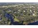 Aerial view showcasing lakefront homes and landscape at 5910 Lake Emma Ct, Groveland, FL 34736