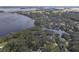 Aerial view showcasing the waterfront property with lush landscaping and serene lake surroundings at 5910 Lake Emma Ct, Groveland, FL 34736