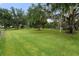 Large grassy backyard with mature trees at 5910 Lake Emma Ct, Groveland, FL 34736