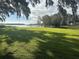 Spacious backyard leading to a tranquil lake with a dock and gazebo at 5910 Lake Emma Ct, Groveland, FL 34736
