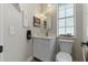 Modern powder room with white vanity and marble countertop at 5910 Lake Emma Ct, Groveland, FL 34736