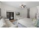 Main bedroom with king bed, French doors, and sitting area at 5910 Lake Emma Ct, Groveland, FL 34736
