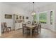Bright dining room with large window and hardwood floors at 5910 Lake Emma Ct, Groveland, FL 34736
