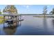 Dock with a boat lift and a cozy gazebo, perfect for lakeside relaxation and recreation at 5910 Lake Emma Ct, Groveland, FL 34736