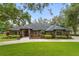 Brick home with landscaped yard and driveway at 5910 Lake Emma Ct, Groveland, FL 34736
