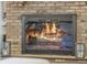 Cozy brick fireplace with glass doors, perfect for creating a warm and inviting ambiance in your home at 5910 Lake Emma Ct, Groveland, FL 34736