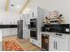 Modern kitchen features double ovens, white cabinets, and a built-in beverage center at 5910 Lake Emma Ct, Groveland, FL 34736