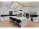 Bright kitchen features white cabinetry, stainless steel appliances, marble countertops, and a large island with seating at 5910 Lake Emma Ct, Groveland, FL 34736