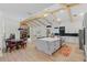 Open-concept kitchen and dining area features a large island, modern appliances, and a cozy breakfast nook at 5910 Lake Emma Ct, Groveland, FL 34736