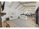 Open living space with vaulted ceilings, and views into the kitchen and backyard at 5910 Lake Emma Ct, Groveland, FL 34736