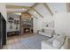 Spacious living area with a brick fireplace, vaulted ceilings and light beige sofas at 5910 Lake Emma Ct, Groveland, FL 34736
