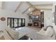 Living room features a brick fireplace, vaulted ceilings, and access to the backyard at 5910 Lake Emma Ct, Groveland, FL 34736