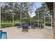 Screened patio with seating area and fire pit at 5910 Lake Emma Ct, Groveland, FL 34736