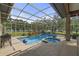 Enclosed pool and spa area overlooking lush landscaping and a serene lake at 5910 Lake Emma Ct, Groveland, FL 34736