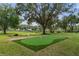 Beautiful putting green in backyard is great for practicing your golf game at 5910 Lake Emma Ct, Groveland, FL 34736