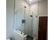 Modern shower with glass enclosure and white subway tile at 5910 Lake Emma Ct, Groveland, FL 34736