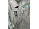 Contemporary shower featuring large-format marble-look tile and a black rain shower head at 5910 Lake Emma Ct, Groveland, FL 34736
