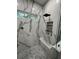 Modern shower featuring marble-look tile, a built-in bench, and a sleek black showerhead at 5910 Lake Emma Ct, Groveland, FL 34736