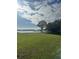 Lush green lawn extends to the lake, featuring a dock and gazebo for enjoying the views at 5910 Lake Emma Ct, Groveland, FL 34736
