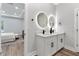 Bright bathroom featuring a double vanity with modern sinks, white countertops, and circular light-up mirrors at 8264 Sw 128Th Ter, Dunnellon, FL 34432