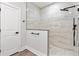 New bathroom showcasing a walk-in shower with a black shower head and marble-look tiling at 8264 Sw 128Th Ter, Dunnellon, FL 34432