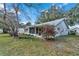 View of the backyard and patio area, featuring a screened-in porch. Nice landscaping at 8862 Sw 92Nd St # D, Ocala, FL 34481