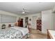 Cozy bedroom featuring a ceiling fan, wood furniture, and access to an en-suite bathroom for added convenience at 8862 Sw 92Nd St # D, Ocala, FL 34481