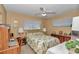 Bright bedroom featuring two windows, ceiling fan, wood accents, and ample natural light, perfect for a guest room at 8862 Sw 92Nd St # D, Ocala, FL 34481