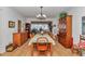Elegant dining room featuring a table with green cloth, wooden chairs, and a hutch, perfect for entertaining guests at 8862 Sw 92Nd St # D, Ocala, FL 34481
