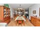 Dining room featuring wooden table and chairs, a hutch, and access to the kitchen, creating a welcoming atmosphere at 8862 Sw 92Nd St # D, Ocala, FL 34481