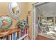 Entryway with a globe, mirror, and view of the screened-in porch, enhancing the home's charm and appeal at 8862 Sw 92Nd St # D, Ocala, FL 34481