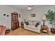Comfortable living room with a neutral sofa, wood floors, decorative lamps, and a charming wooden secretary desk at 8862 Sw 92Nd St # D, Ocala, FL 34481