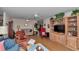 Cozy living room featuring wood floors, ceiling fan, and a built-in entertainment center with plants and decorative items at 8862 Sw 92Nd St # D, Ocala, FL 34481