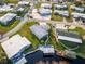 Aerial view of waterfront home with a boat dock, landscaping, and well-manicured lawn at 920 Morningview Dr, Tavares, FL 32778